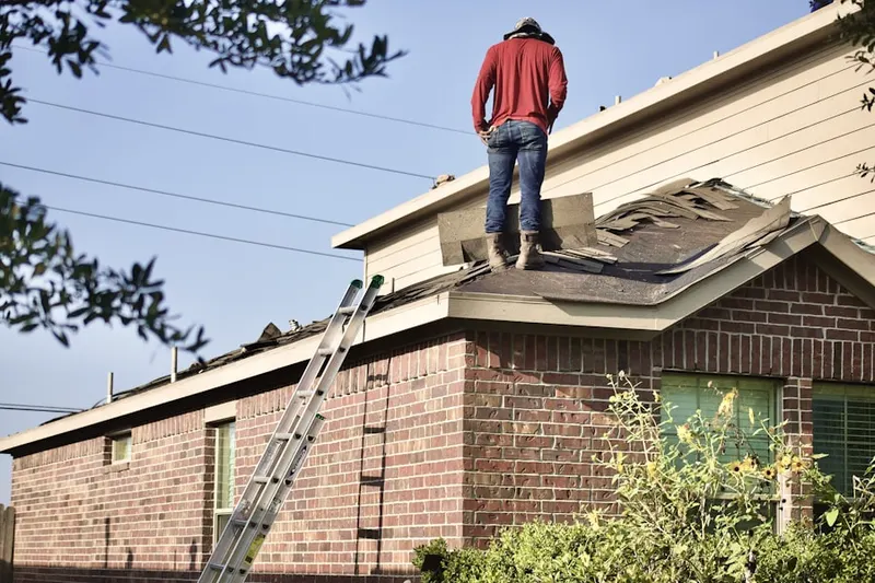Professional roofer working on a residential roof in Eureka